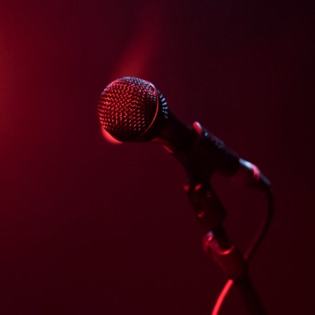 A photograph of a microphone tinted red.